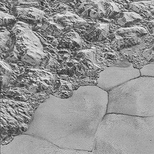 Mountains of ice along a portion of smoother ice planes on Pluto’s surface.